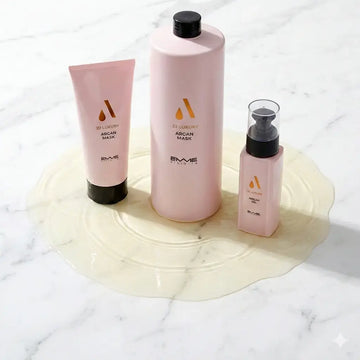 Emme Diciotto 22 Luxury Argan hair care set including masks and oil bottle on a marble surface.